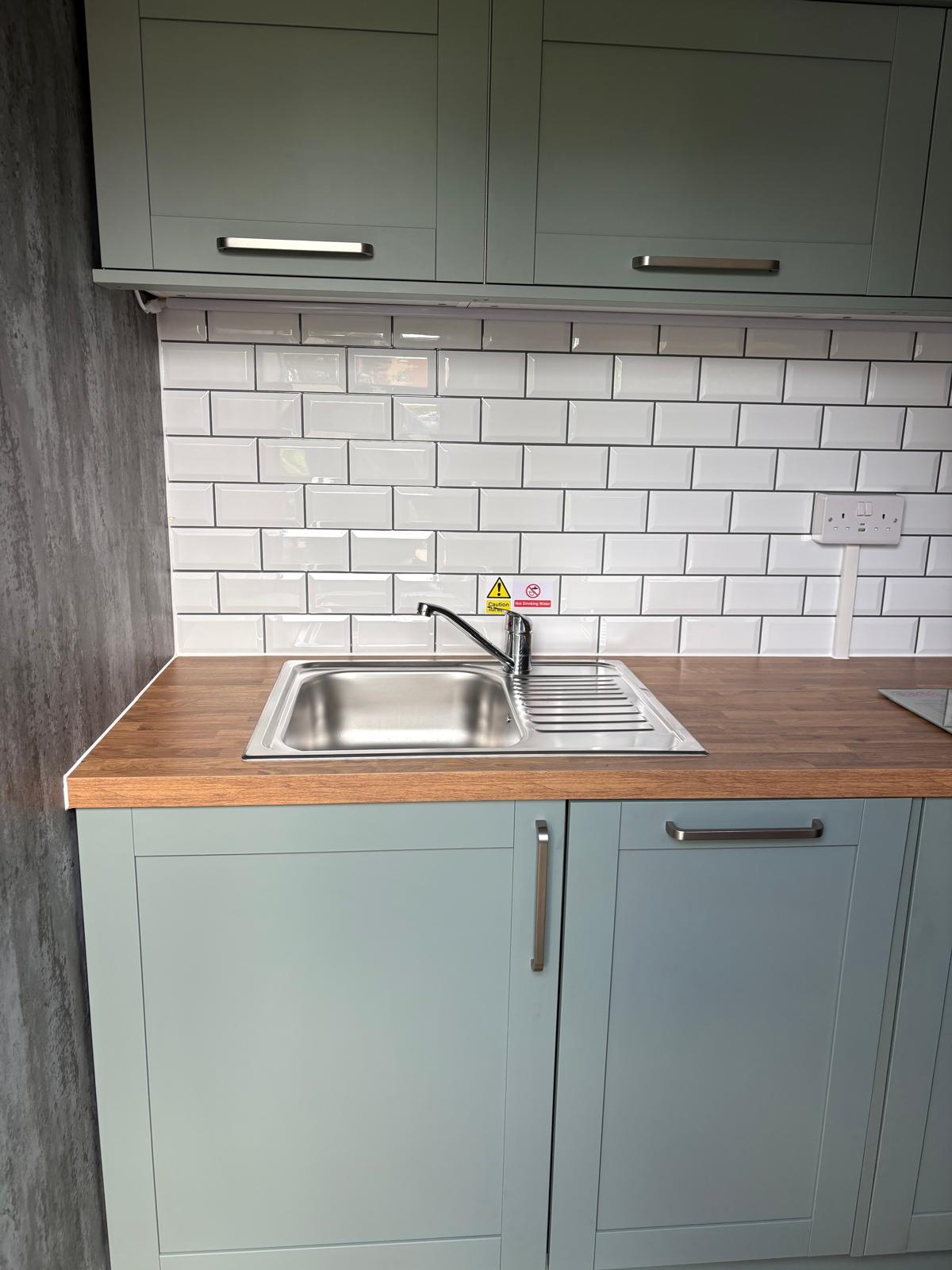 Stainless steel sink with hot and cold water
